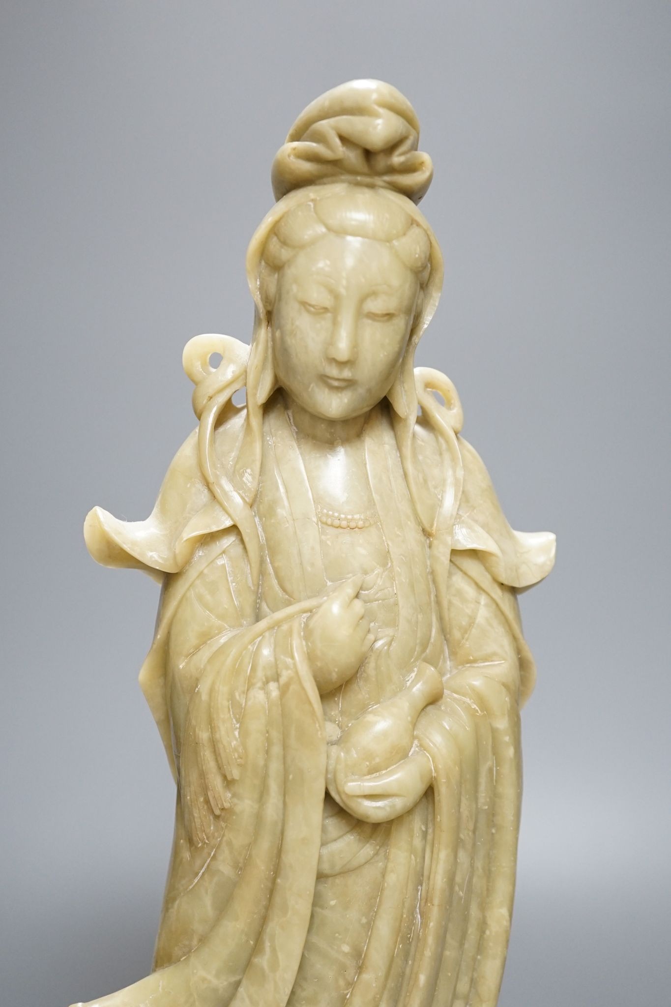 A large Chinese soapstone figure of Guanyin, on base, 40cm
